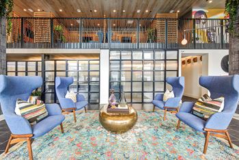 a lobby with blue chairs and a round table at Coda at Bryant Street, Washington